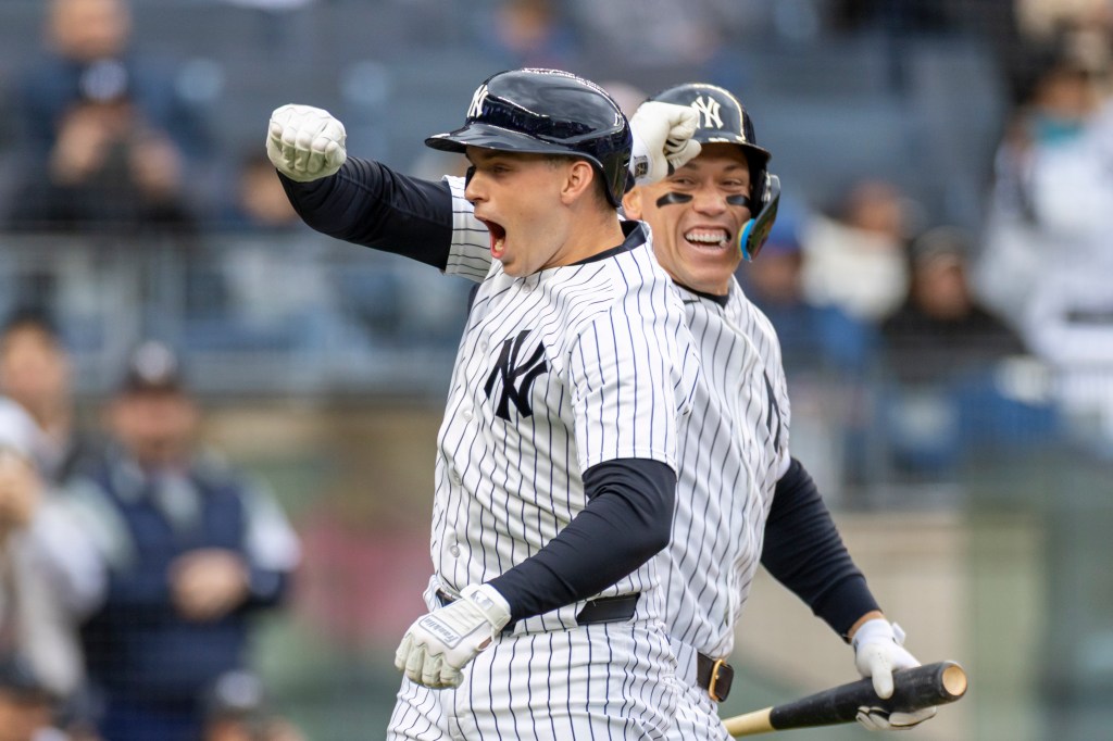 New York Yankees first baseman Ben Rice (22) celebrates with New York Yankees right fielder Aaron Judge (99) after he scores on his solo homer.