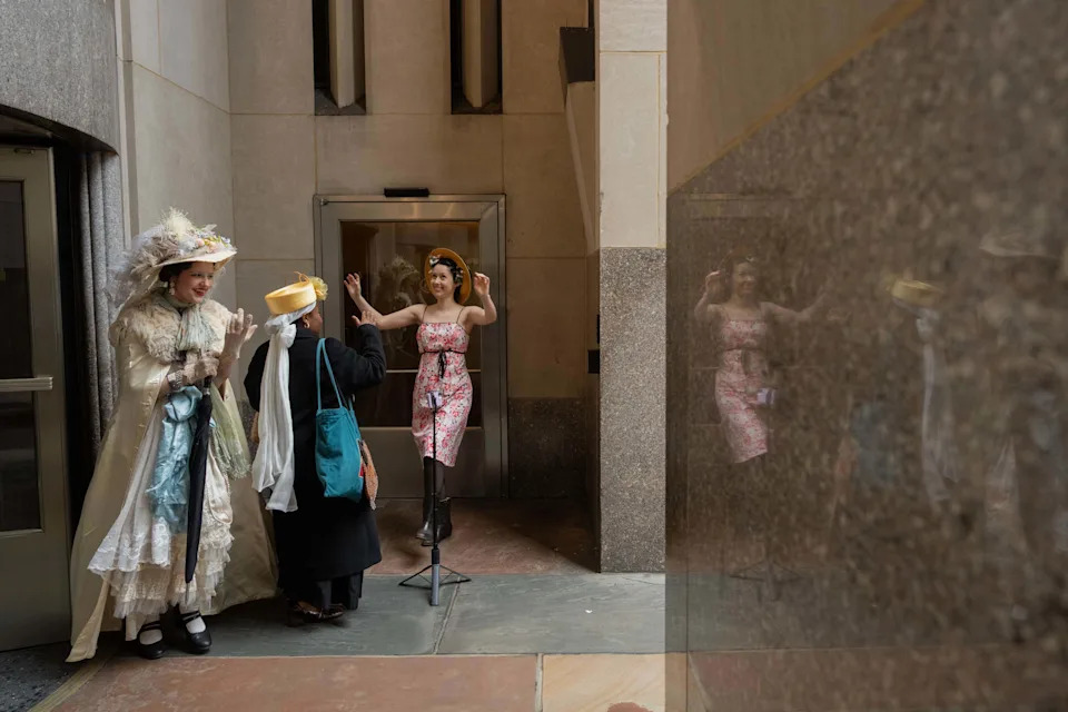 Fatimah Kihulo, Annamaria Holston, and Adriana Tesoro, film each other during the Easter Parade and Bonnet Festival on Fifth Avenue, Sunday, April 5, 2026, in New York. (AP Photo/Adam Gray)