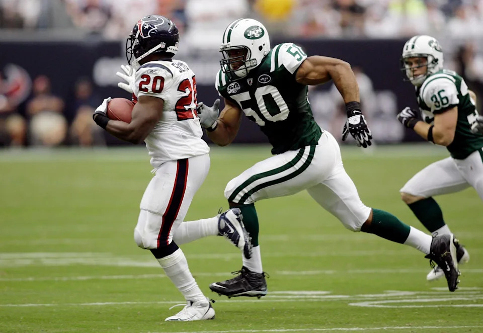 New York Jets linebacker Vernon Gholston chases Houston Texans running back Steve Slaton.