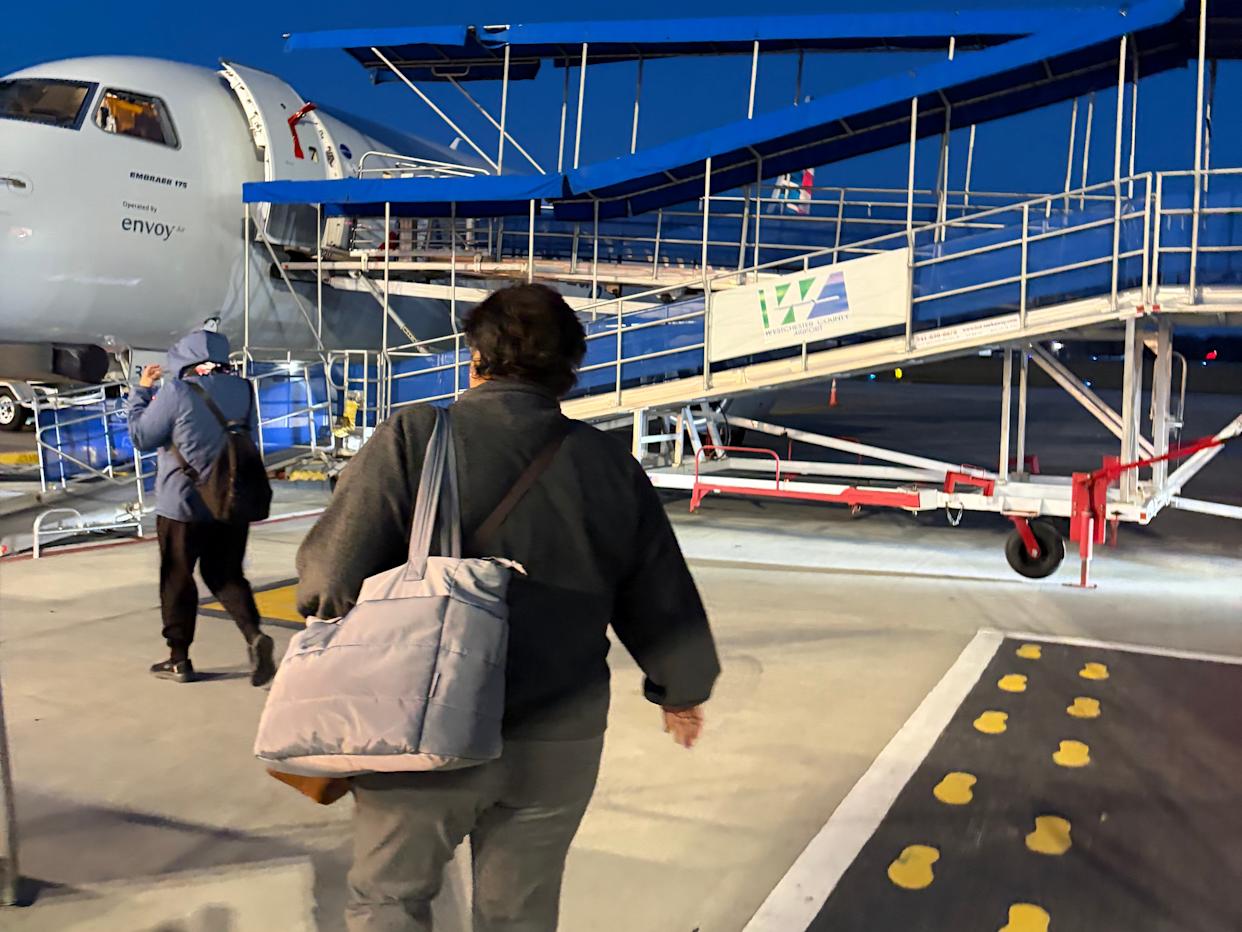 Woman boarding plane
