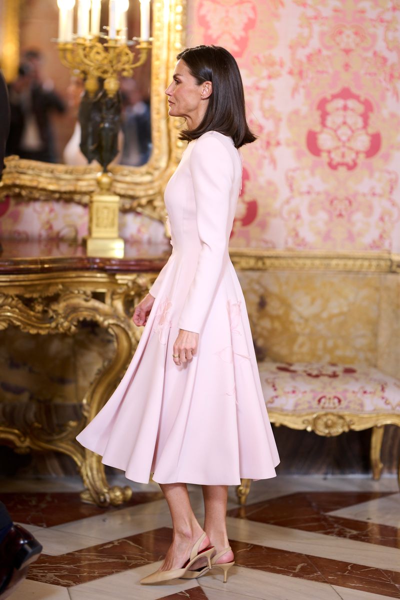In 2024, the Queen leaned into romanticism with this Pedro del Hierro crepe dress featuring intricate 3D floral embellishments and a soft pastel palette.