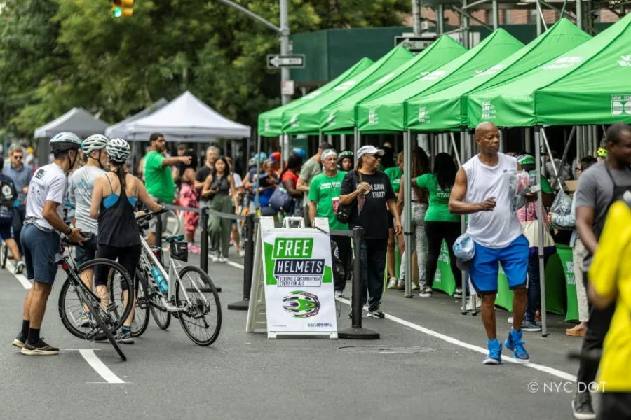 NYC DOT employees distribute free bike helmets at Manhattan Summer Streets 2023.(Credit: NYC DOT)