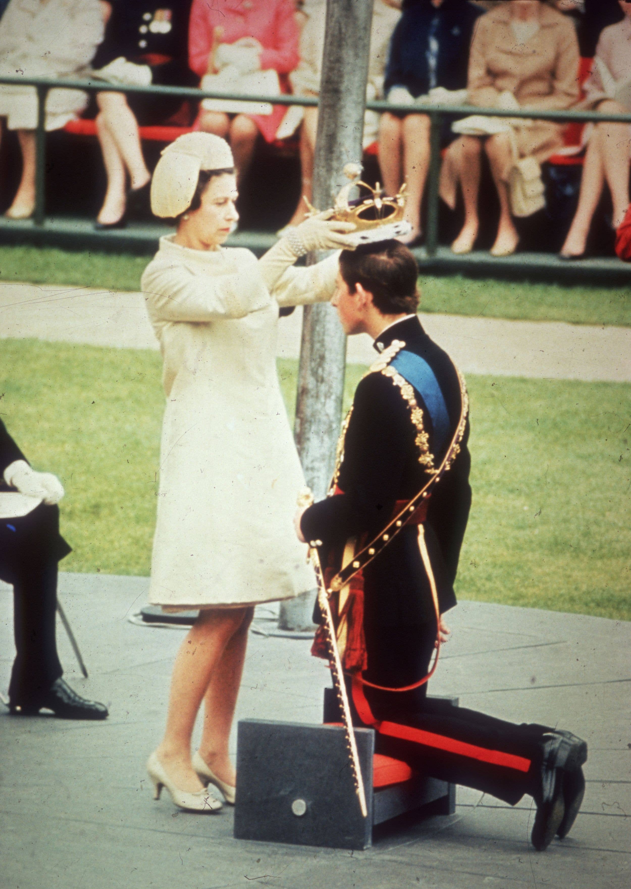 1st July 1969:  Queen Elizabeth II crowns her son Charles, Prince of Wales, during his investiture ceremony at Caernarvon Castle.  (Photo by Hulton Archive/Getty Images)
