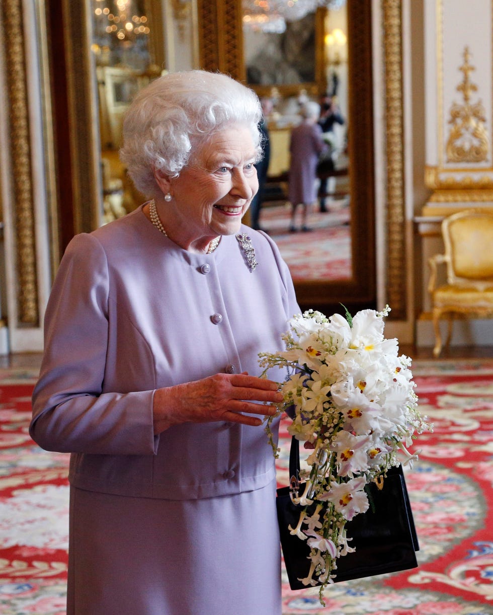 london, england may 29: queen elizabeth ii is presented with a replica of the coronation bouquet by the worshipful company of gardeners in the white drawing room at buckingham palace on may 29, 2013 in london, england. david is the son of the late martin longman, of longman's florists, who made the original bouquet for the monarch in 1953, used photos from the coronation day and an oil painting of the flowers to help her recreate the exact bouquet. the celebrations begin on june 02, 2013. (photo by jonathan brady wpa pool/getty images)