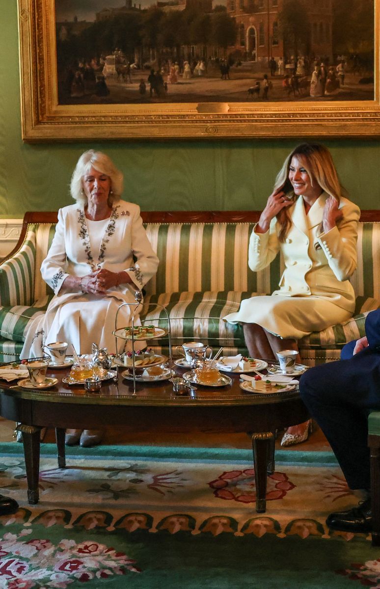 Queen Camilla echoed that visual direction. After arriving earlier in a blush Dior coat dress, she transitioned into a light-toned ensemble with delicate detailing along the front and collar.