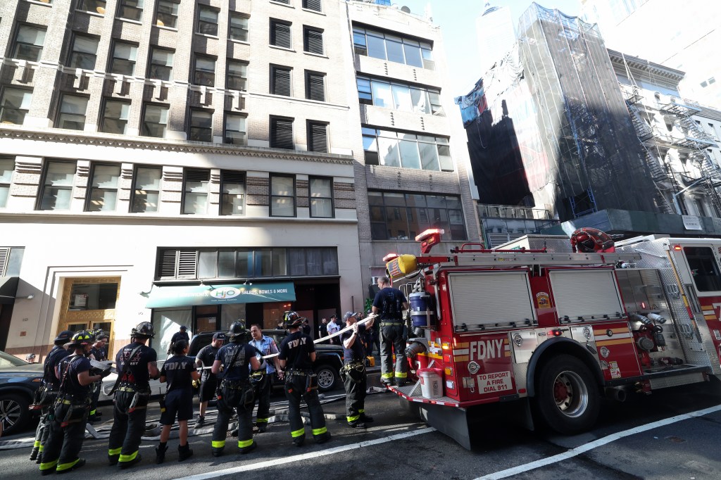A picture of a fire truck in front of the building. 