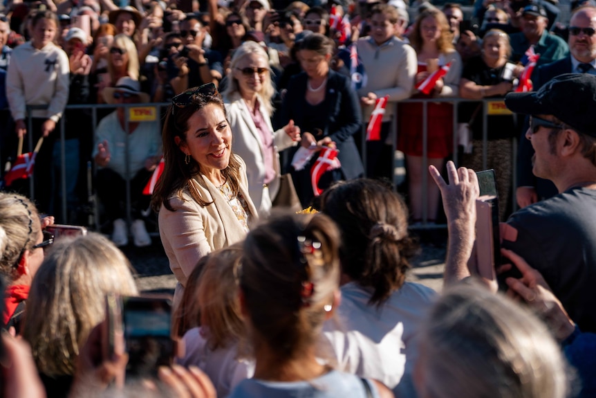 A crowd gathered smiling and waving
