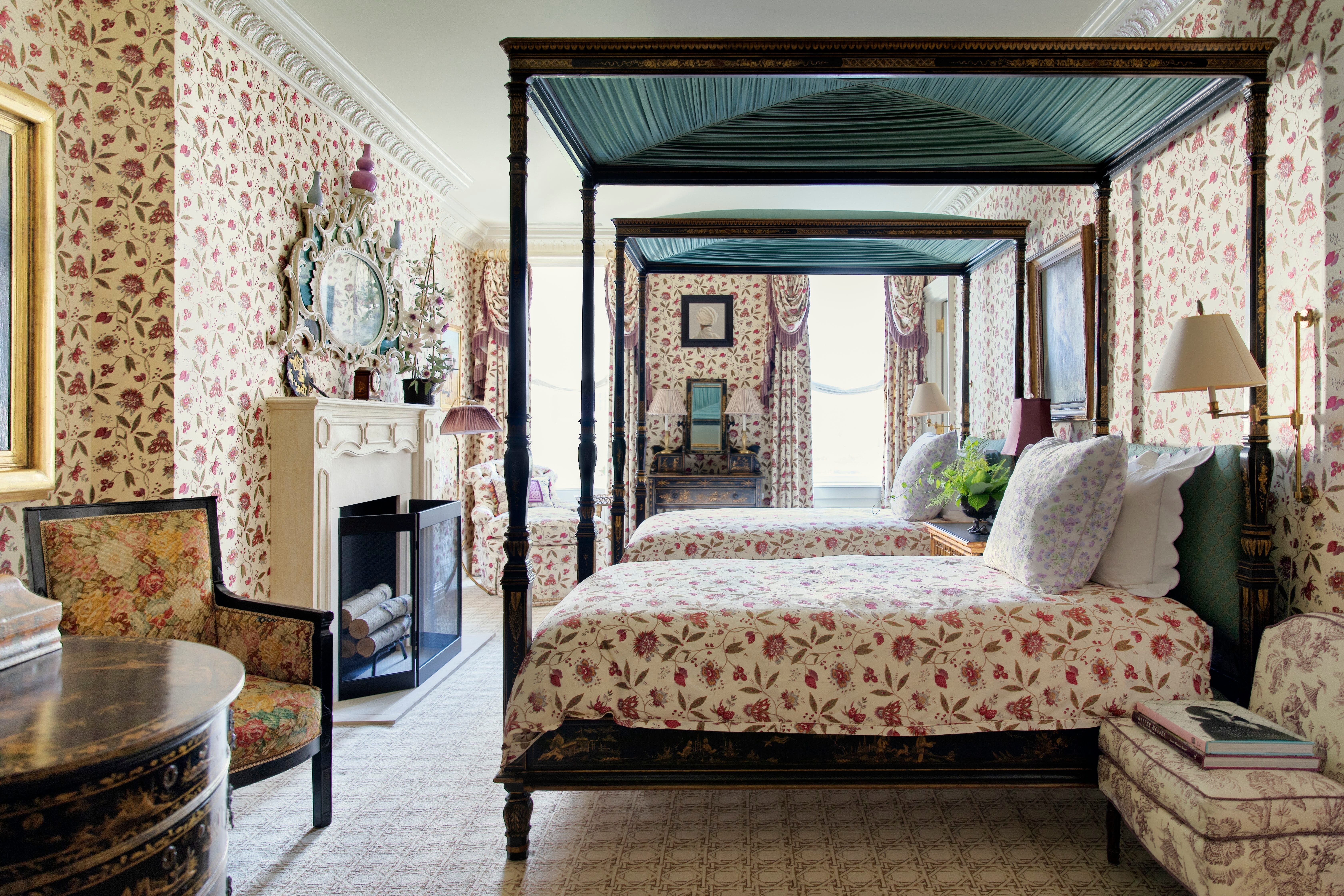 Luxurious bedroom with canopy beds and floral decor.