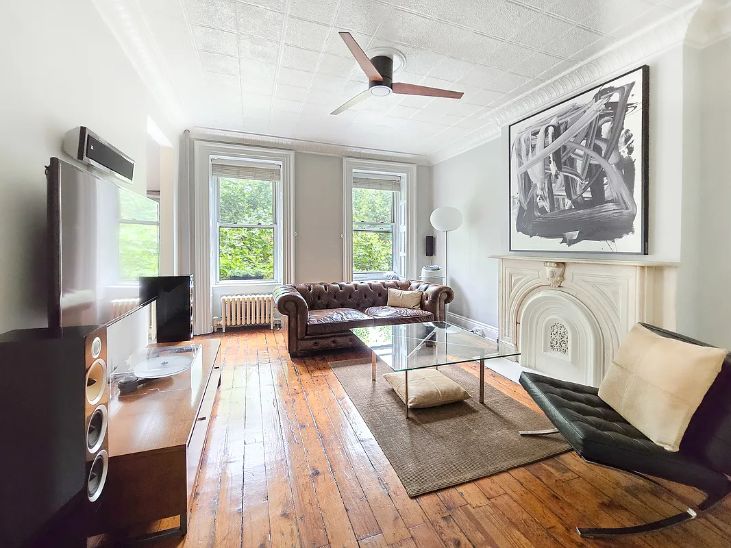 living room with wood floor, tin ceiling