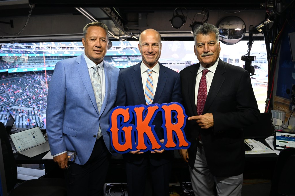 Gary Cohen, Ron Darling, and Keith Hernandez hold up an orange and blue sign that says "GKR" in celebration of 20 years on SNY.
