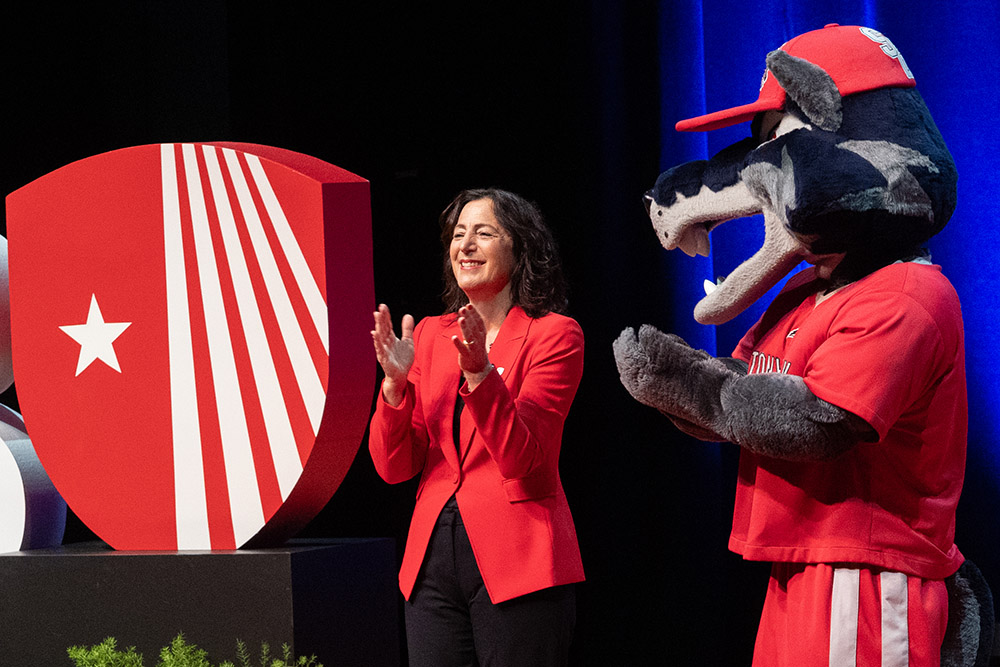 President Andrea Goldsmith and Wolfie at the 2025 State of the University Address.