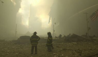 Emergency workers and a flag at ground zero on the evening of Sept. 11, 2001 after the September 11 terrorist attacks on the World Trade Center in New York City. (AP Photo/Mark Lennihan)