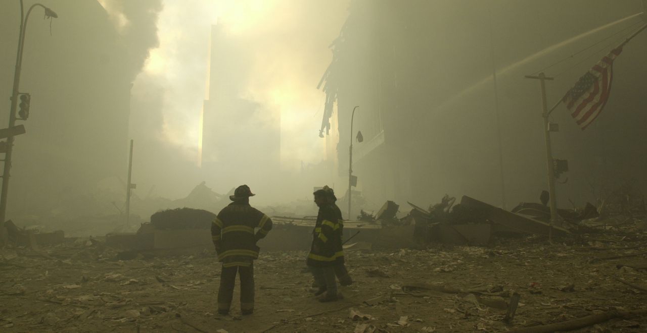 Emergency workers and a flag at ground zero on the evening of Sept. 11, 2001 after the September 11 terrorist attacks on the World Trade Center in New York City. (AP Photo/Mark Lennihan)