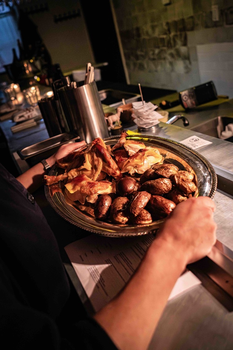 Chicken and potatoes on a silver platter at Gigi's.