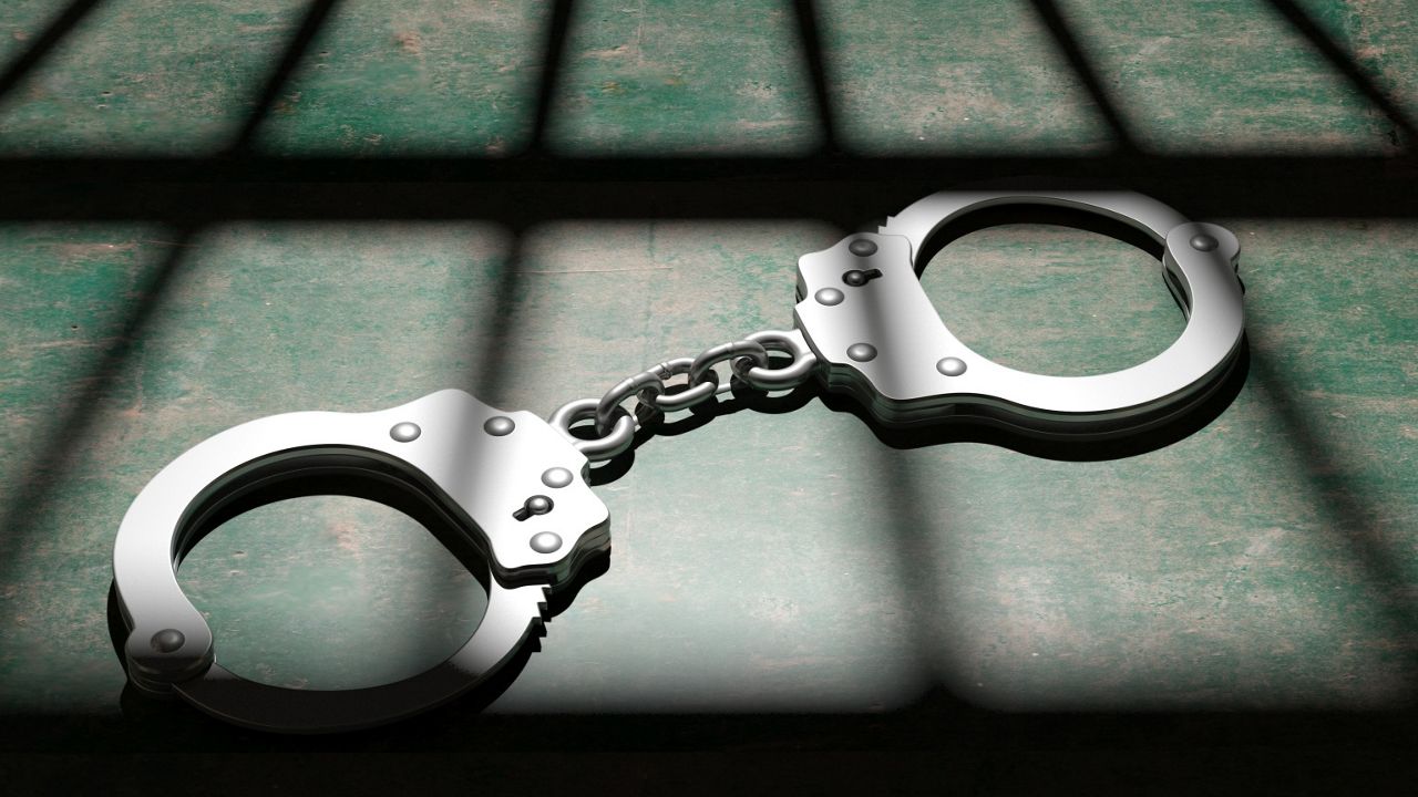 handcuffs on the floor of a jail cell