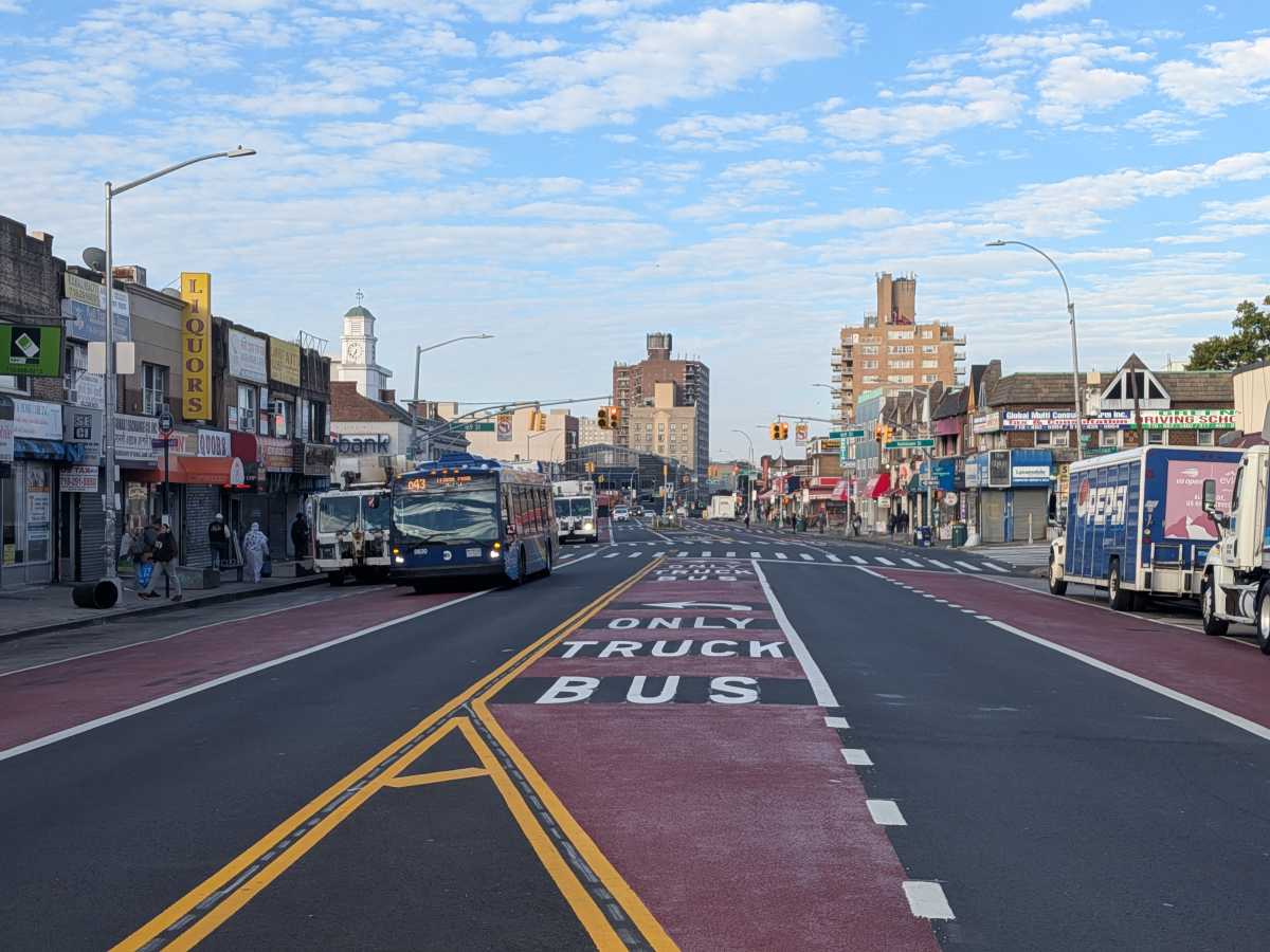 a street with bus, vehicle and parking lanes