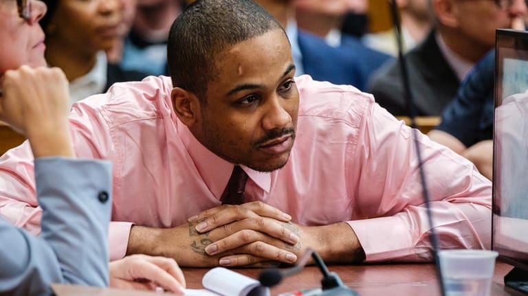 Defendant Guy Rivera looks on as his attorney delivers closing...