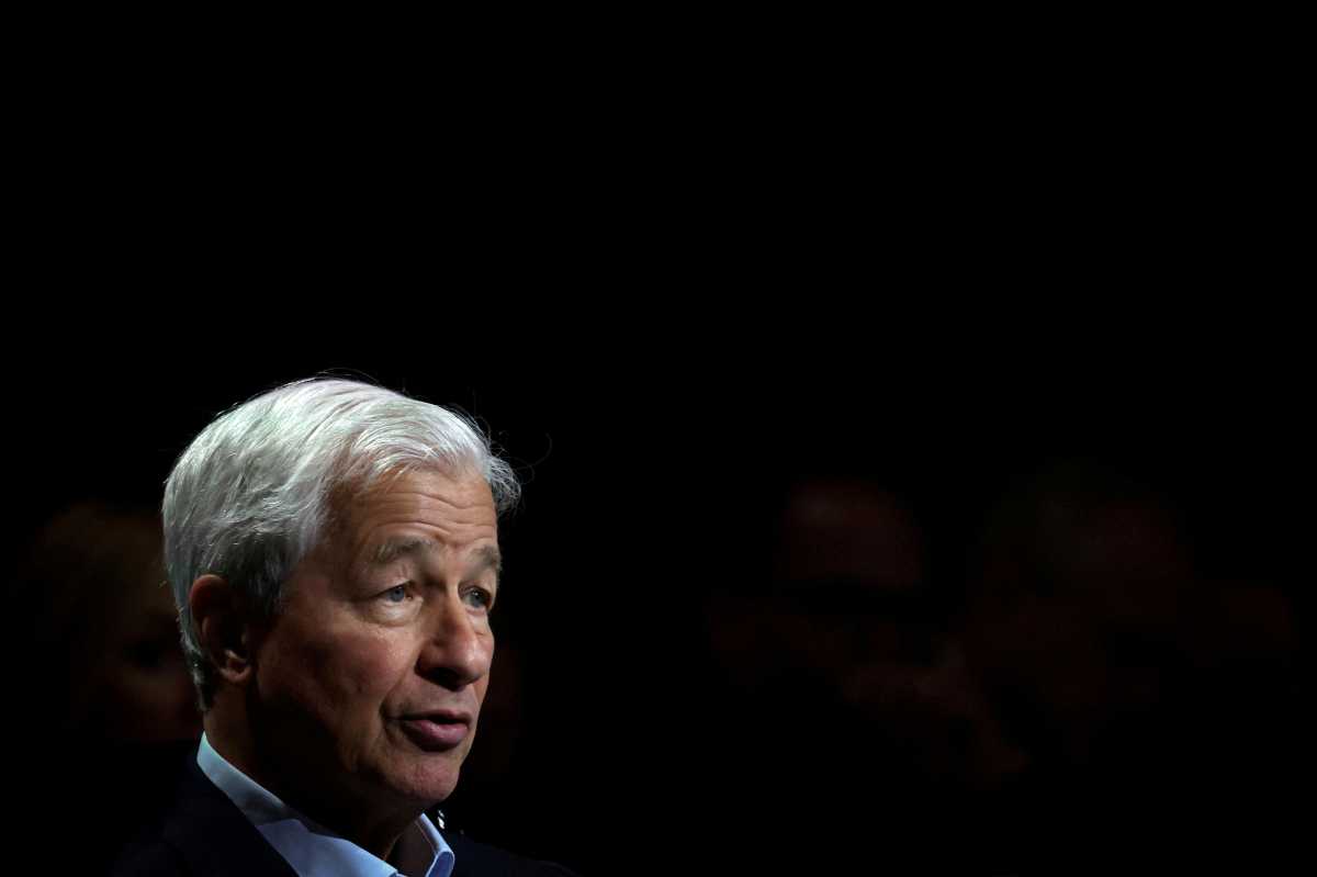 man with white hair against black backdrop