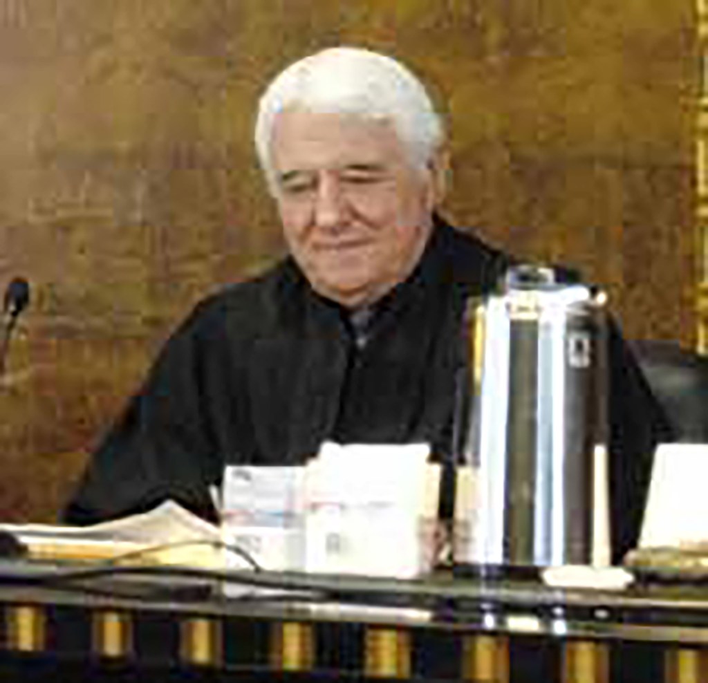 Judge Thomas James McAvoy seated at a desk.