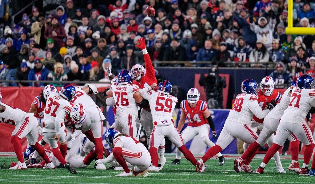 New York Giants kicker Younghoe Koo (37) kicks during the first half of an NFL football game against the New England Patriots.