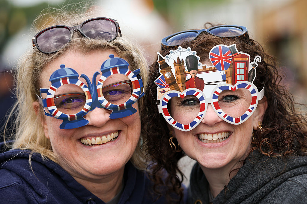 Ginny Musil (L) and Stacie Mikels both of Front Royal, Virginia, pose for a photo wearing decorative glasses during a parade and block party on day four of the state visit of King Charles III and Queen Camilla on April 30, 2026 in Front Royal.