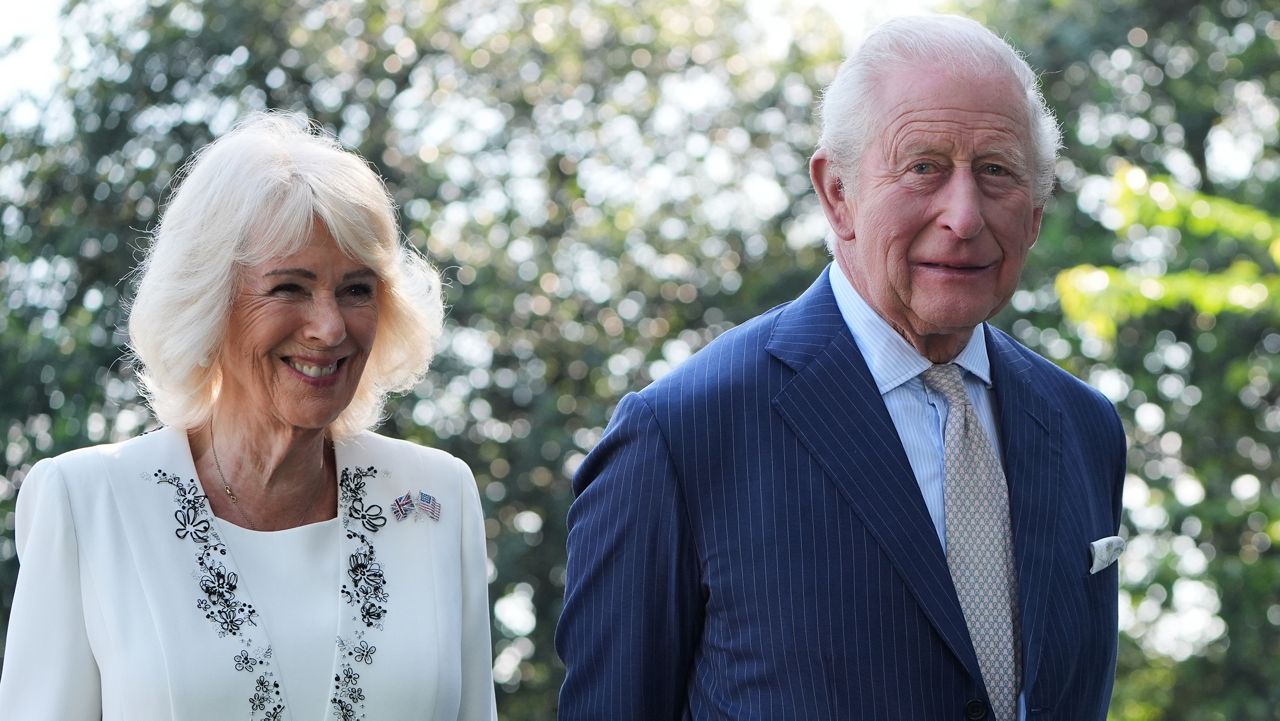 Britain's King Charles III and Queen Camilla stand next to the White House bee hive on the South Lawn of the White House, Monday, April 27, 2026, in Washington. (AP Photo/Alex Brandon, Pool)