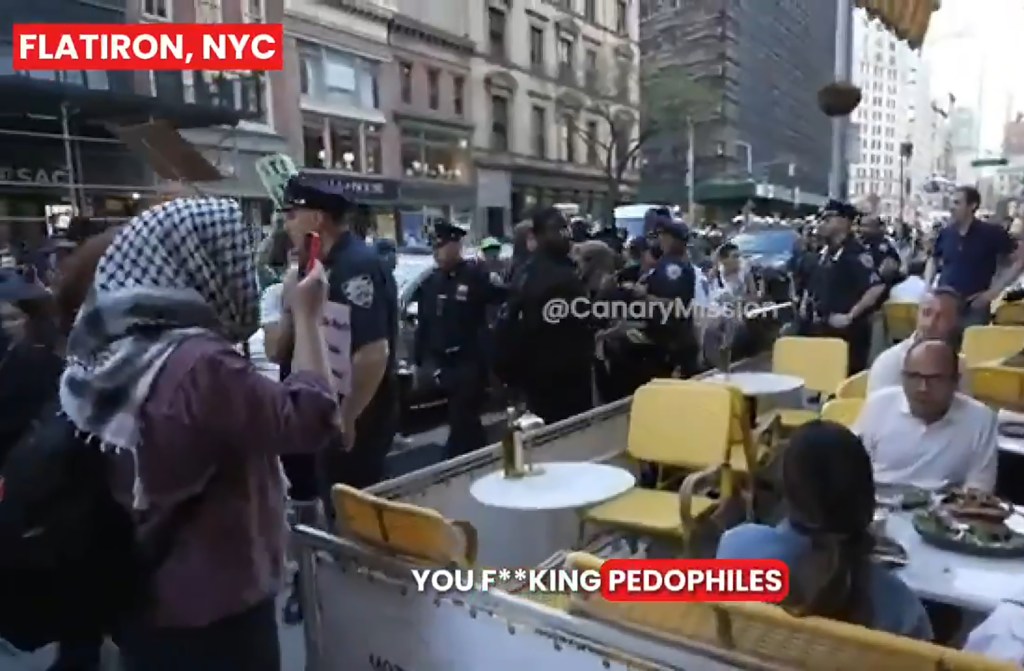 Protesters shouting insults at diners at an outdoor restaurant in Flatiron, NYC.