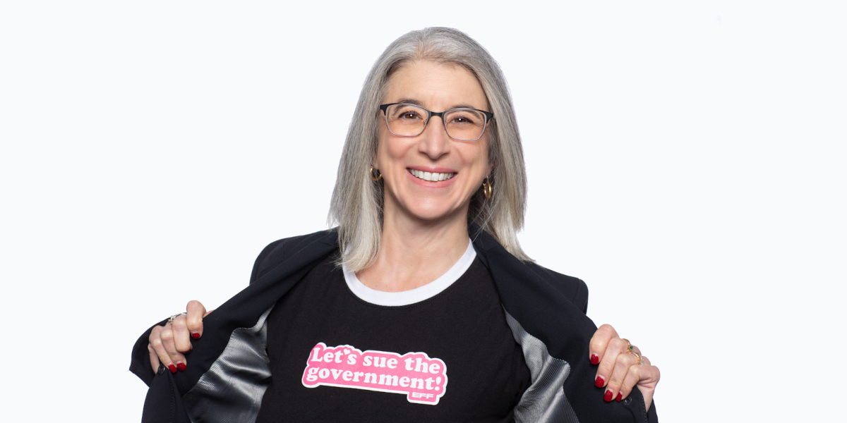 Cindy Cohn wearing a t-shirt that says Let's Sue the Government