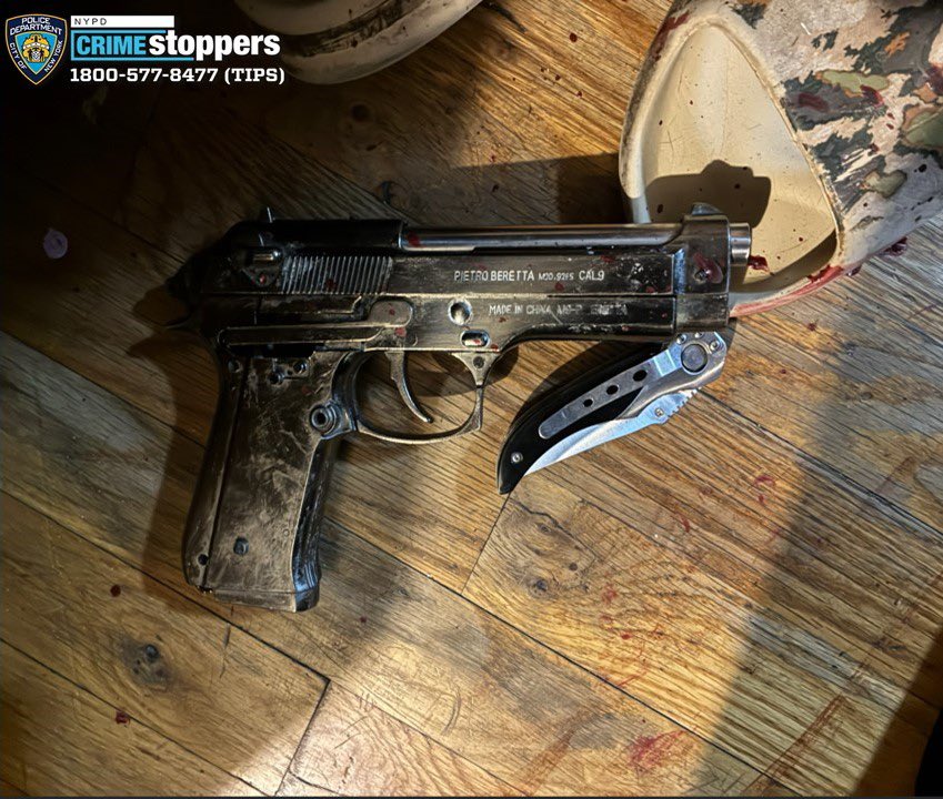 A firearm with a folding knife attached to it.