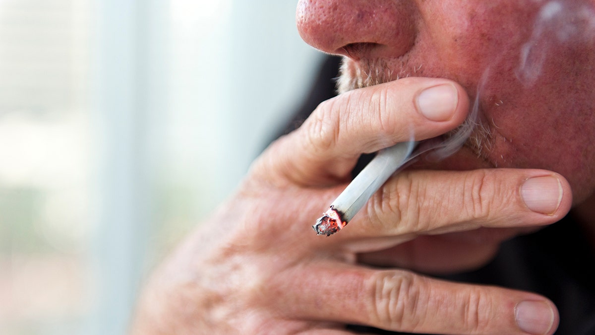 A man smoking a cigarette in a close-up view