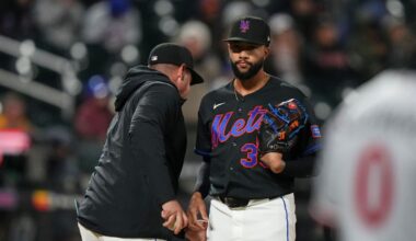 New York Mets pitcher Devin Williams, right, hands the ball to manager Carlos Mendoza as he leaves during the ninth inning of a baseball game against the Minnesota Twins Tuesday, April 21, 2026, in New York. (AP Photo/Frank Franklin II)