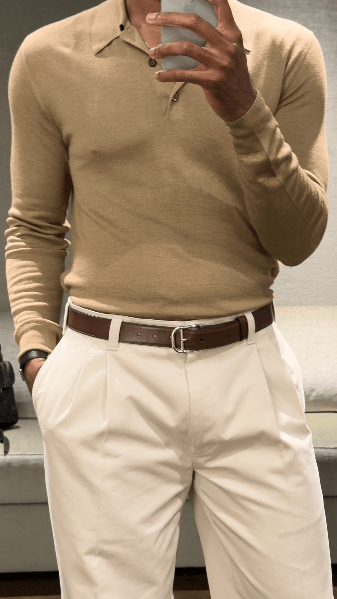 Image may contain Clothing Shirt Long Sleeve Sleeve Adult Person Accessories Dress Shirt Belt and Khaki