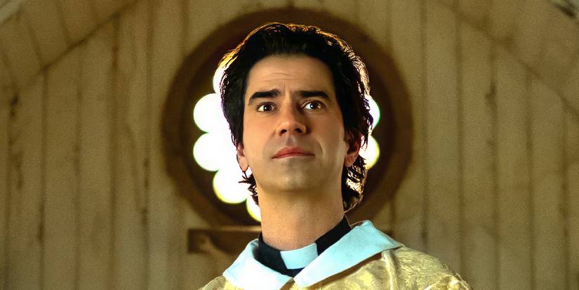 Hamish Linklater in priest vestments inside a church looking to the distance in 'Midnight Mass' (2021).