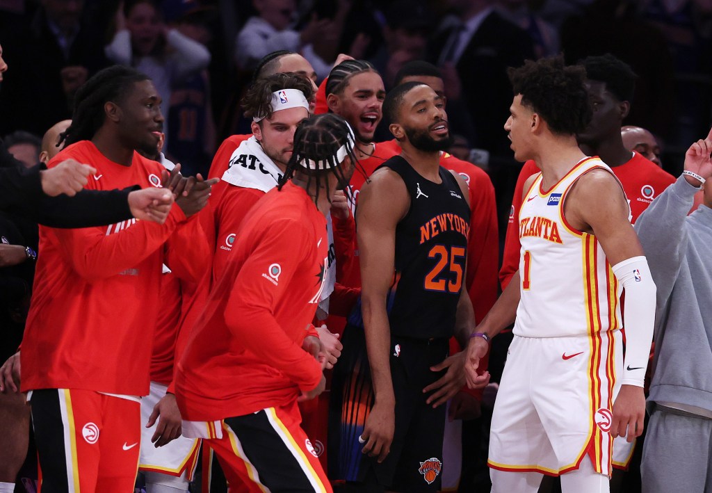 Mikal Bridges of the New York Knicks looks on after missing the final shot, surrounded by celebrating Atlanta Hawks players after their 107-106 victory.