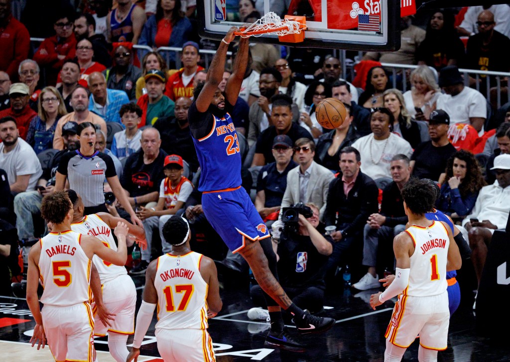 New York Knicks center Mitchell Robinson (23) slam dunks the ball during the second quarter.