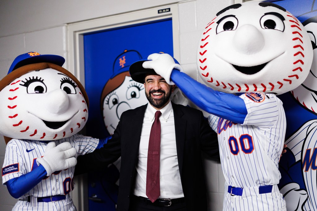 New York City Mayor Zohran Mamdani laughing with Mrs. Met and Mr. Met.