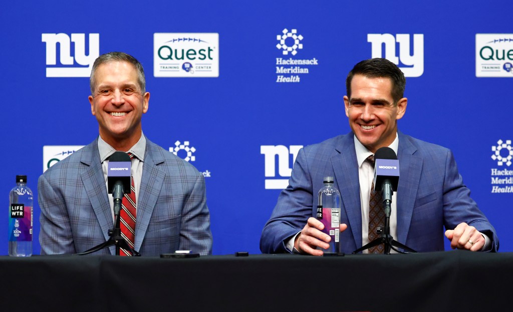 New York Giants head coach John Harbaugh and general manager Joe Schoen smiling while responding to questions.
