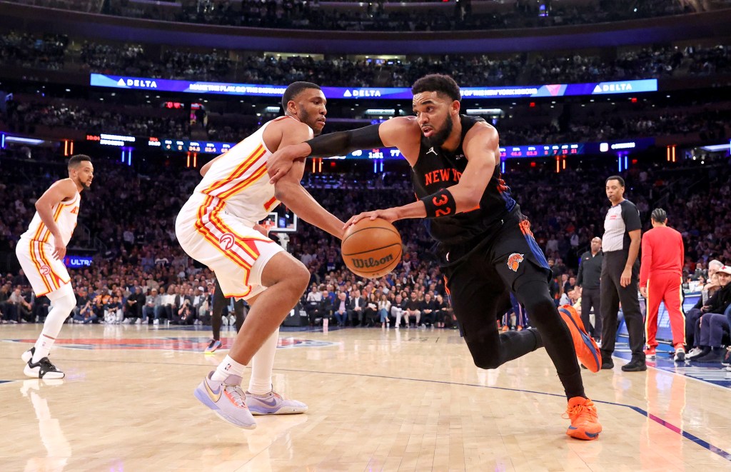 New York Knicks center Karl-Anthony Towns (32) drives to the basket against an Atlanta Hawks player.