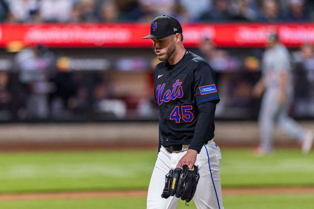 New York Mets pitcher Christian Scott walking off the field after being pulled from the game against the Minnesota Twins.
