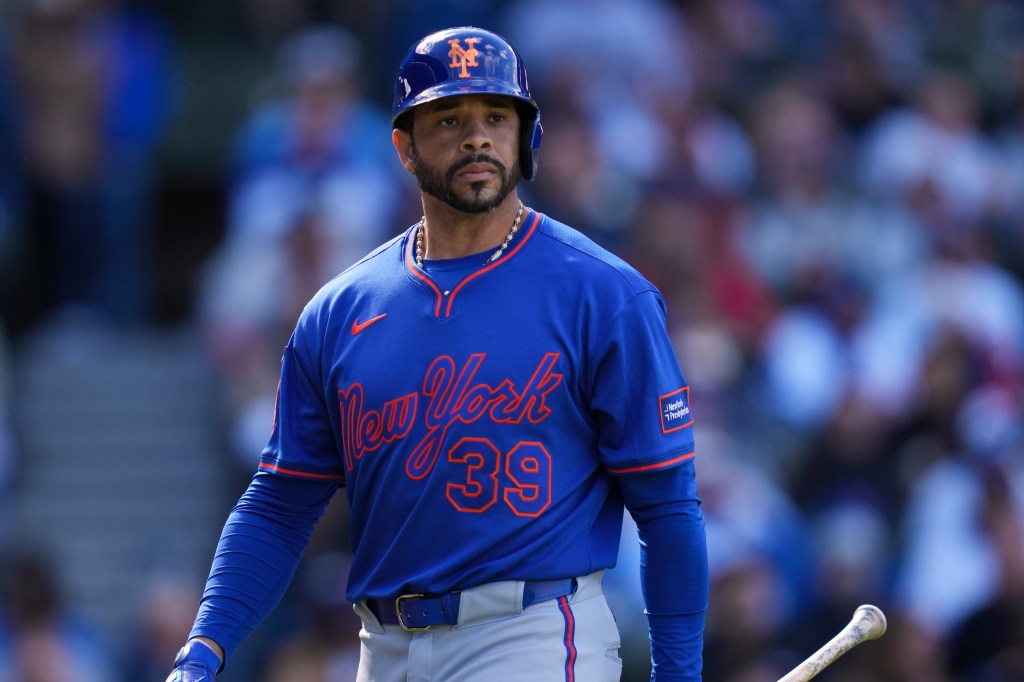 Tommy Pham, wearing a blue New York Mets uniform with number 39, returns to the dugout after striking out.
