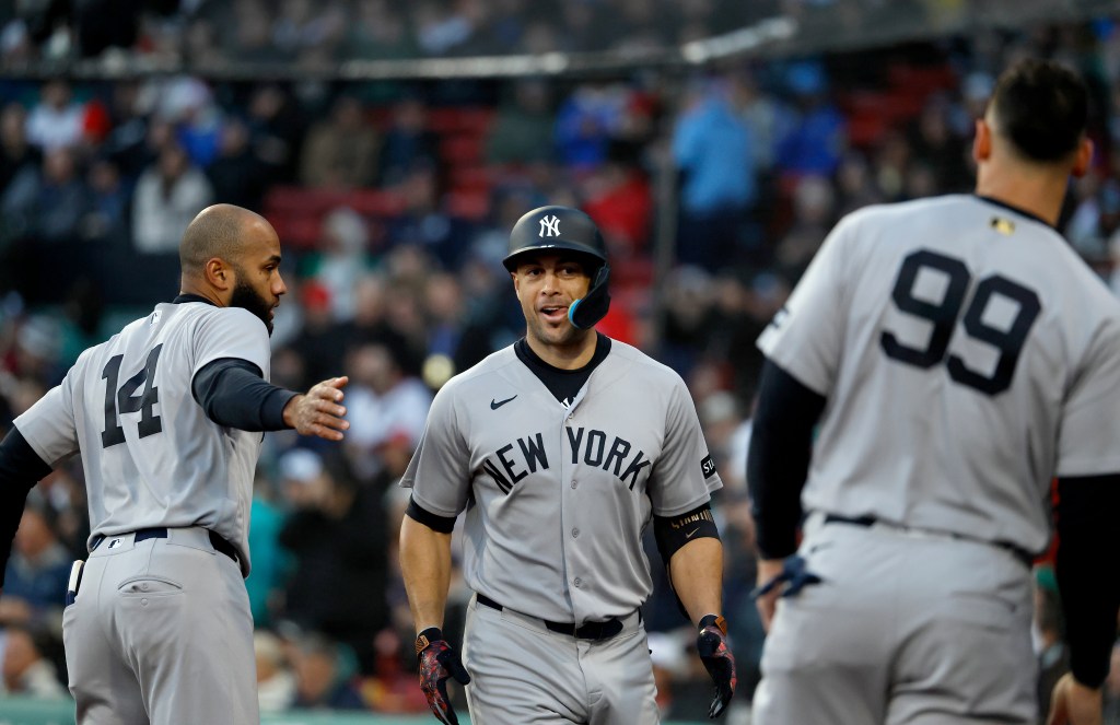 Yankees designated hitter Giancarlo Stanton (27) celebrates with New York Yankees third baseman Amed Rosario (14) and New York Yankees right fielder Aaron Judge (99) after he scores on his solo home run during the second inning on April 21.