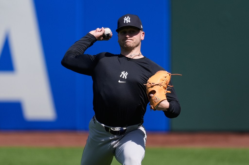 New York Yankees pitcher Cade Winquest warming up for a baseball game.