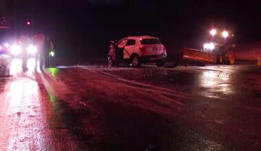 crews respond to car crash on route 7 in niskayuna new york at night. a white car involved in the crash is in the center of the road.