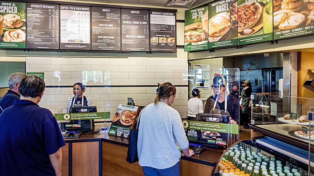 Customers ordering at Panera Bread counter inside Naples Florida bakery
