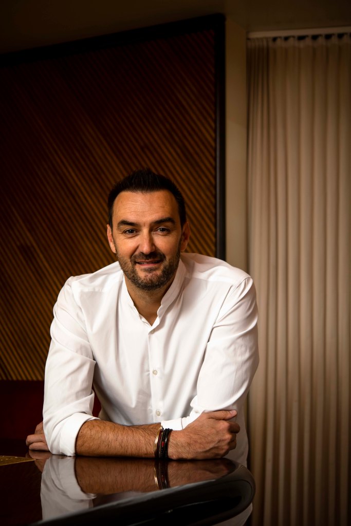 Photo of Chef Cyril Lignac smiling at the camera.