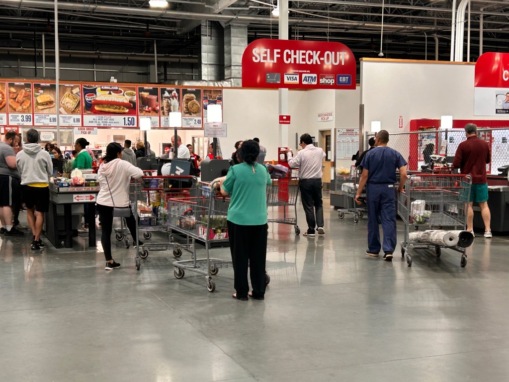People at the self check-out lines and food court in a Costco store in Connecticut.