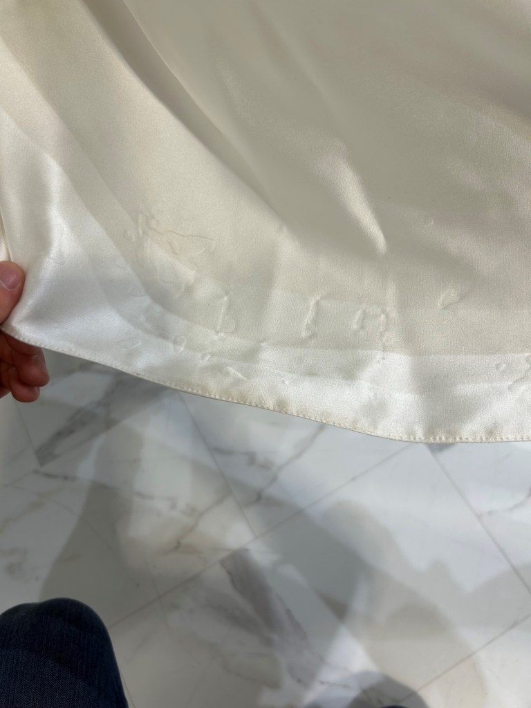 a close up image of the hem of the dress which allegedly show tears
