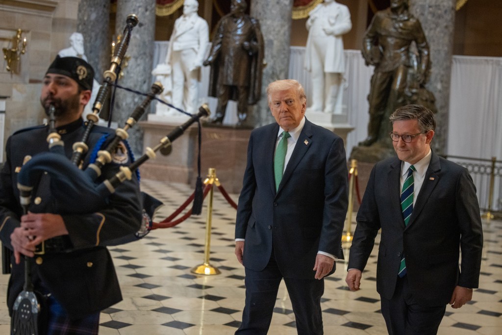 President Donald Trump and Speaker of the House Mike Johnson walking through a hall with a bagpiper.