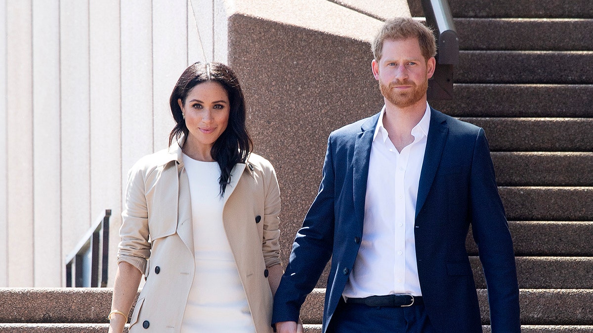 Prince Harry and Meghan Markle walking hand in hand at Sydney Opera House