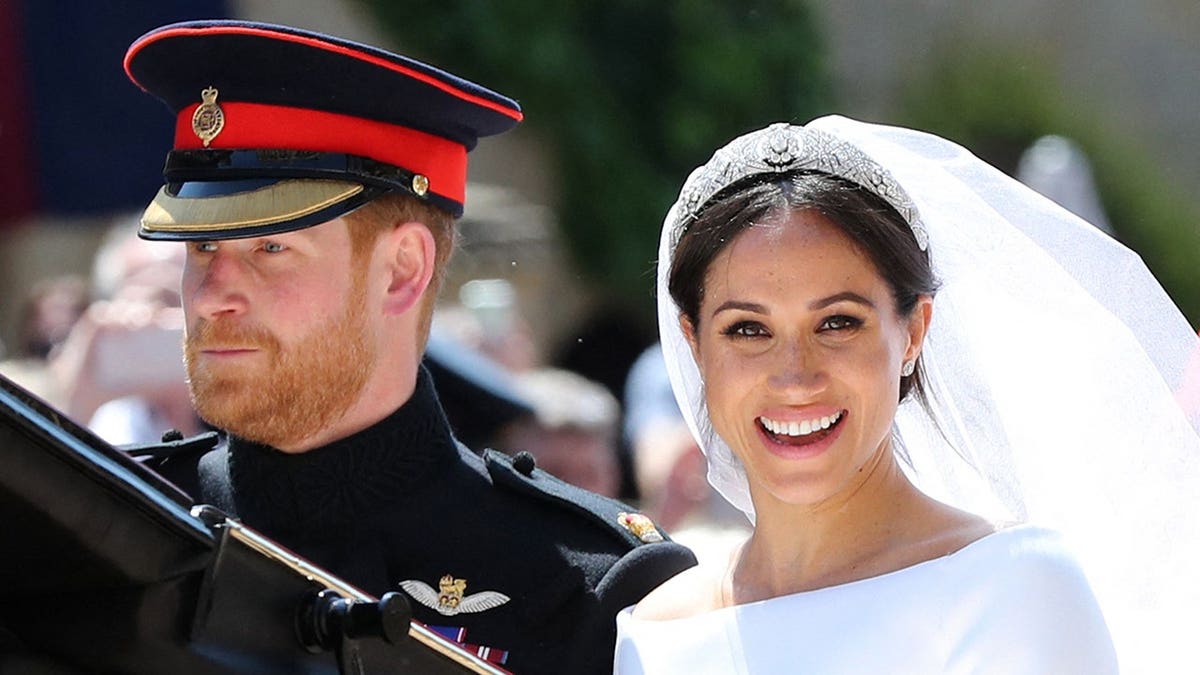 Prince Harry and Meghan Markle riding in a carriage at Windsor Castle